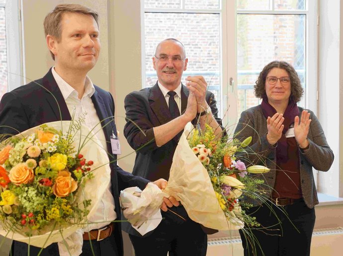 Dennis Pistol (l.) freute sich über die blumenreichen Glückwünsche von Propst Matthias Krüger und Präses Maike Tesch. Blumen für den neuen Propst